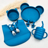 Vaisselle bébé bleu marine complète avec assiette, bol, bavoir et tasse. Coffret ergonomique sécurisé.
